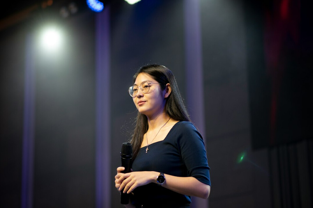 woman speaking confidently on stage