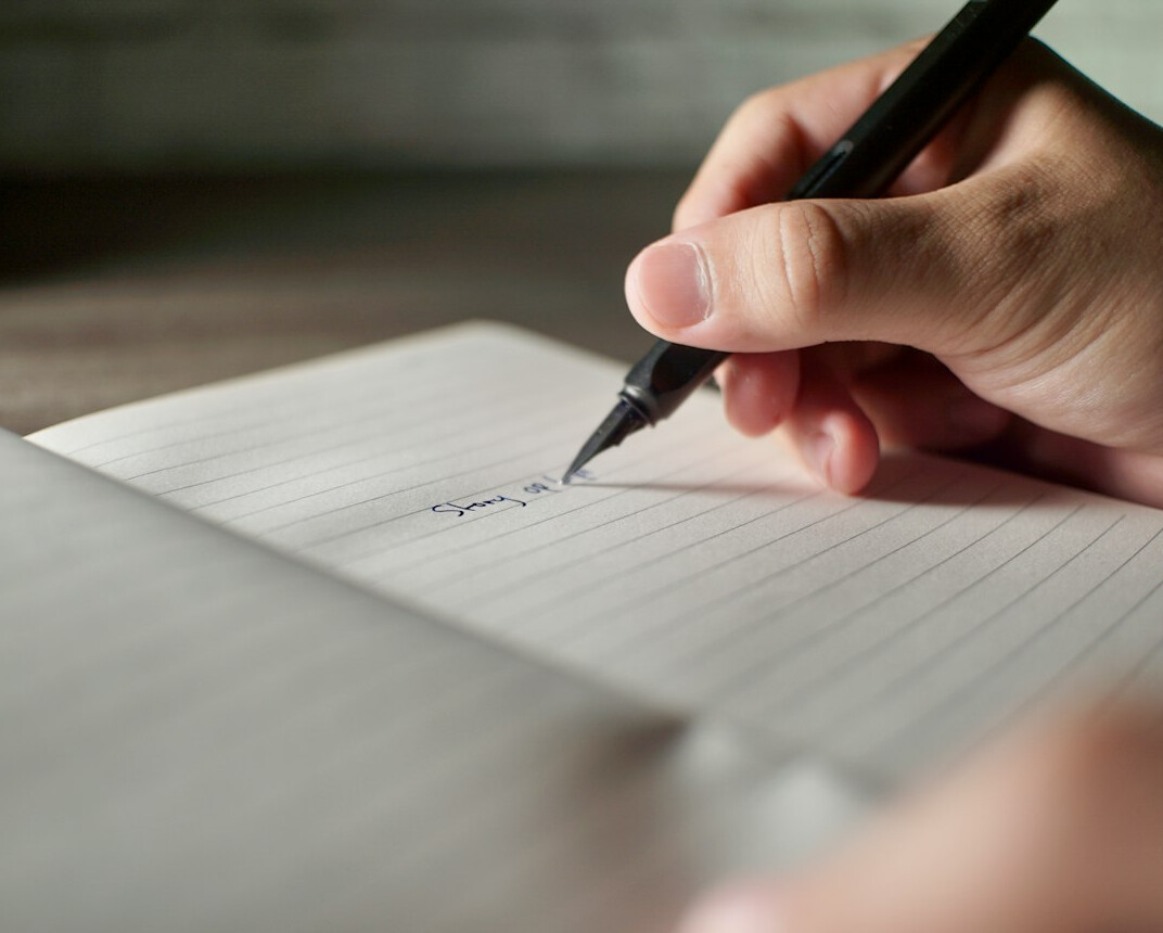 woman writing in notebook